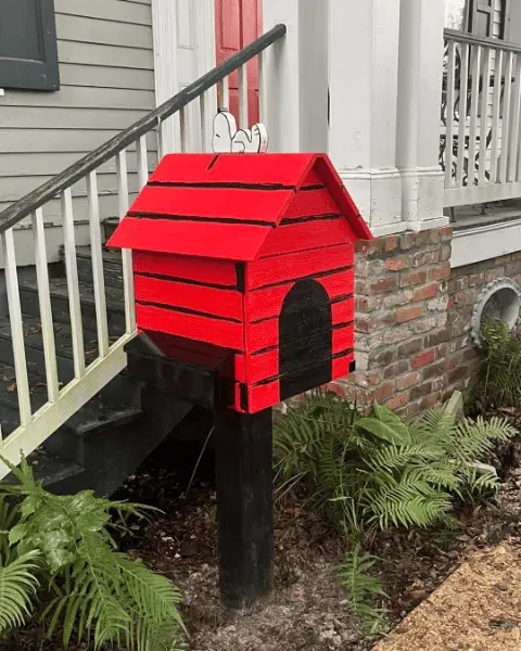 Red Snoopy-style doghouse mailbox built by Vision Handyman
